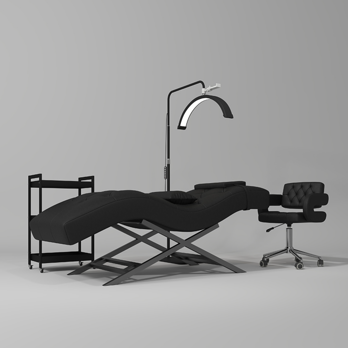 Black massage table with a lamp and chair on a gray background