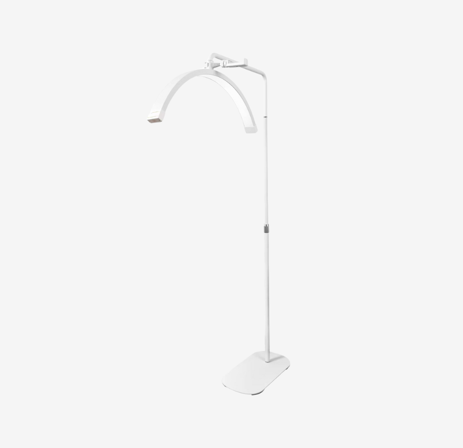 A white free-standing moon light with an adjustable stand height and a curved light fixture at the top.